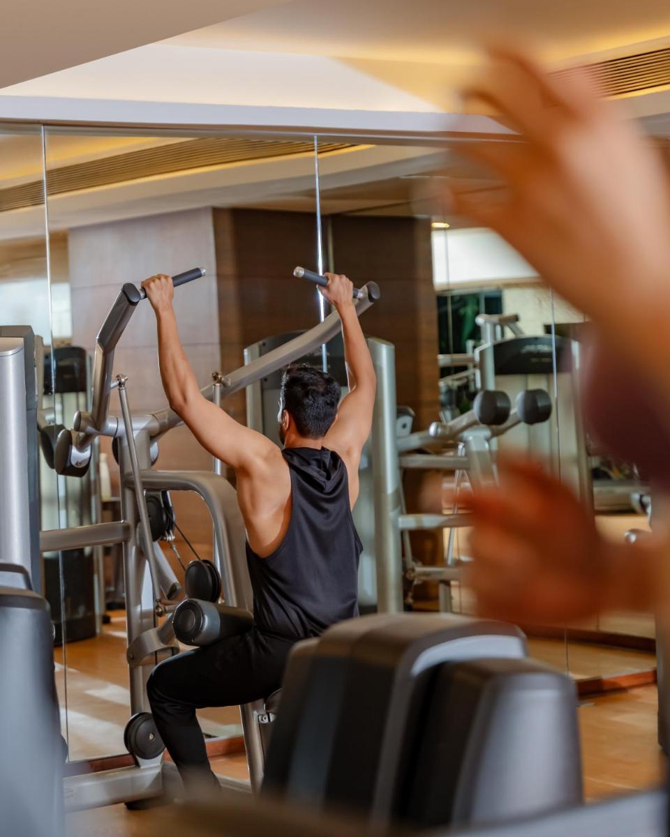 a man exercising on a gym machine at Hyatt Pune in Pune