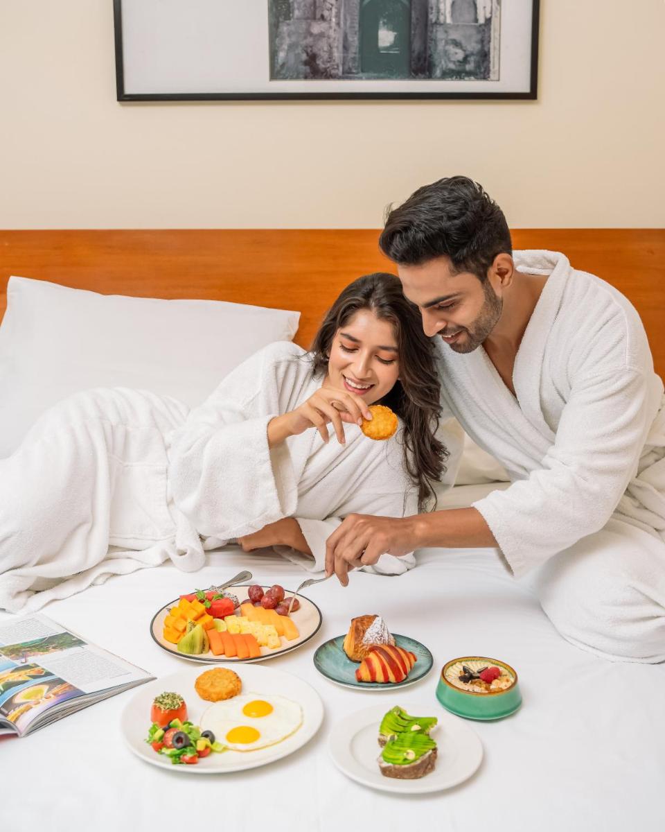 a man and a woman eating food on a table at Hyatt Pune in Pune