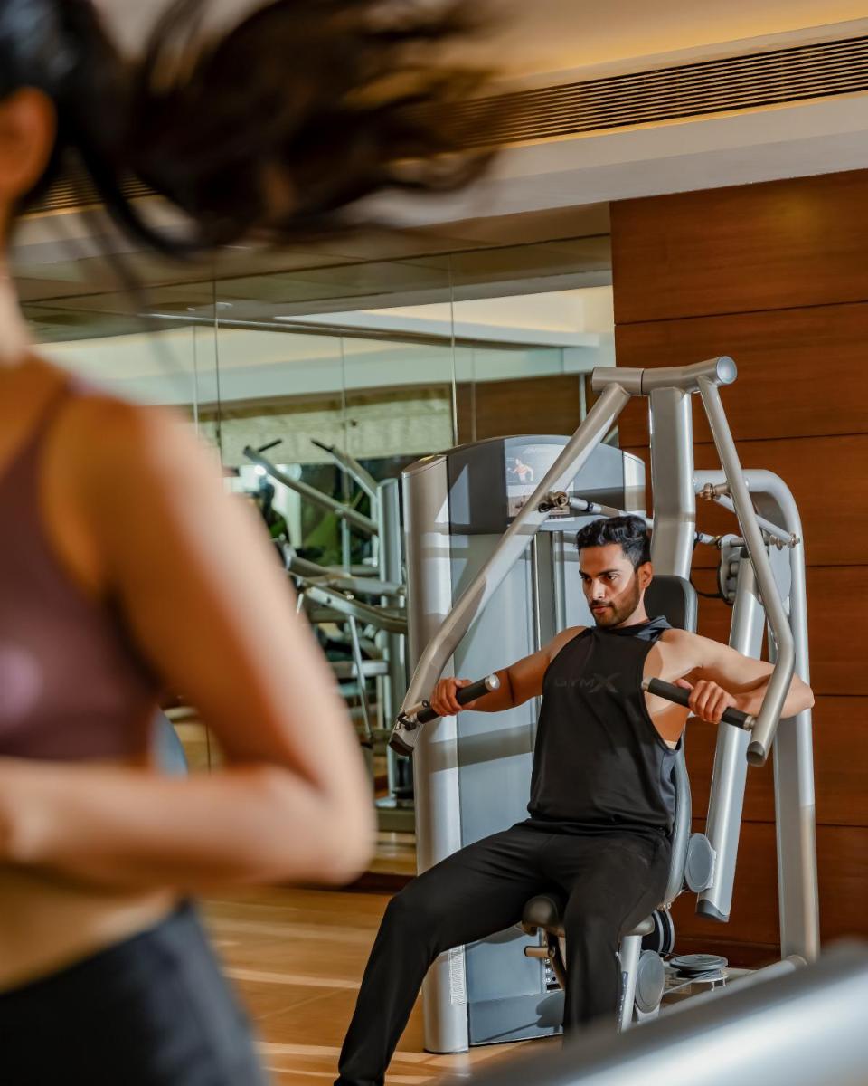 a man exercising on a treadmill in a gym at Hyatt Pune in Pune
