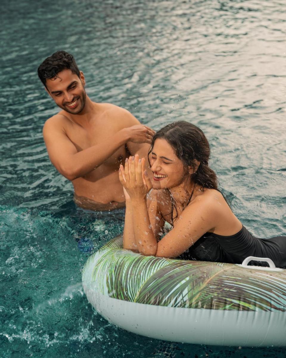 a man and a woman in the water on a raft at Hyatt Pune in Pune