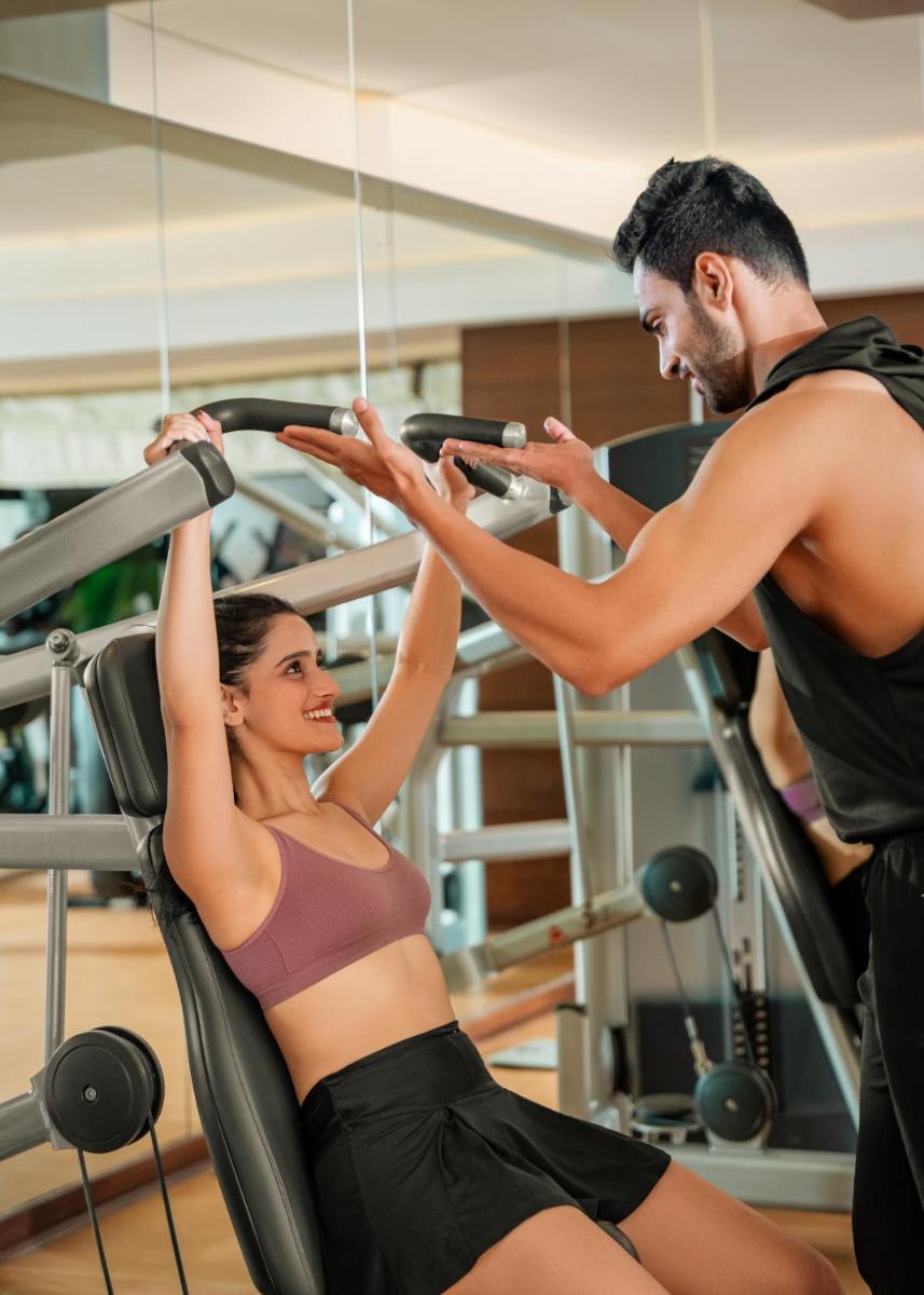 a man and a woman exercising in a gym at Hyatt Pune in Pune
