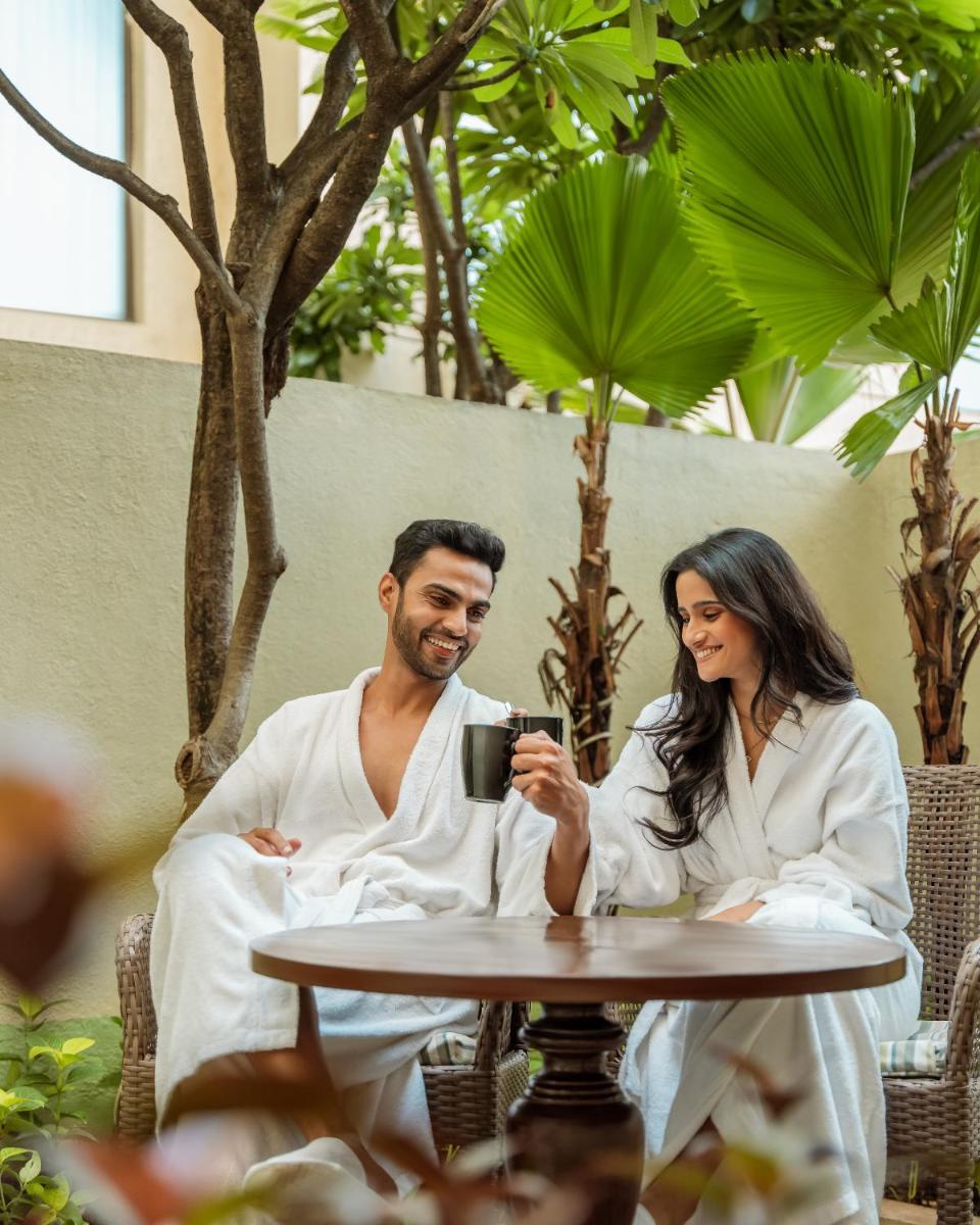 a man and woman in white robes sitting at a table at Hyatt Pune in Pune