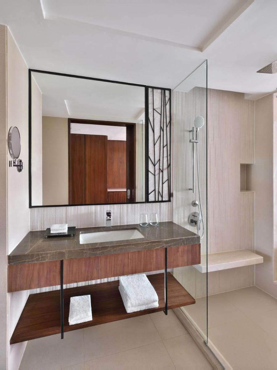 a bathroom with a sink and a mirror at Courtyard by Marriott Mahabaleshwar in Mahabaleshwar