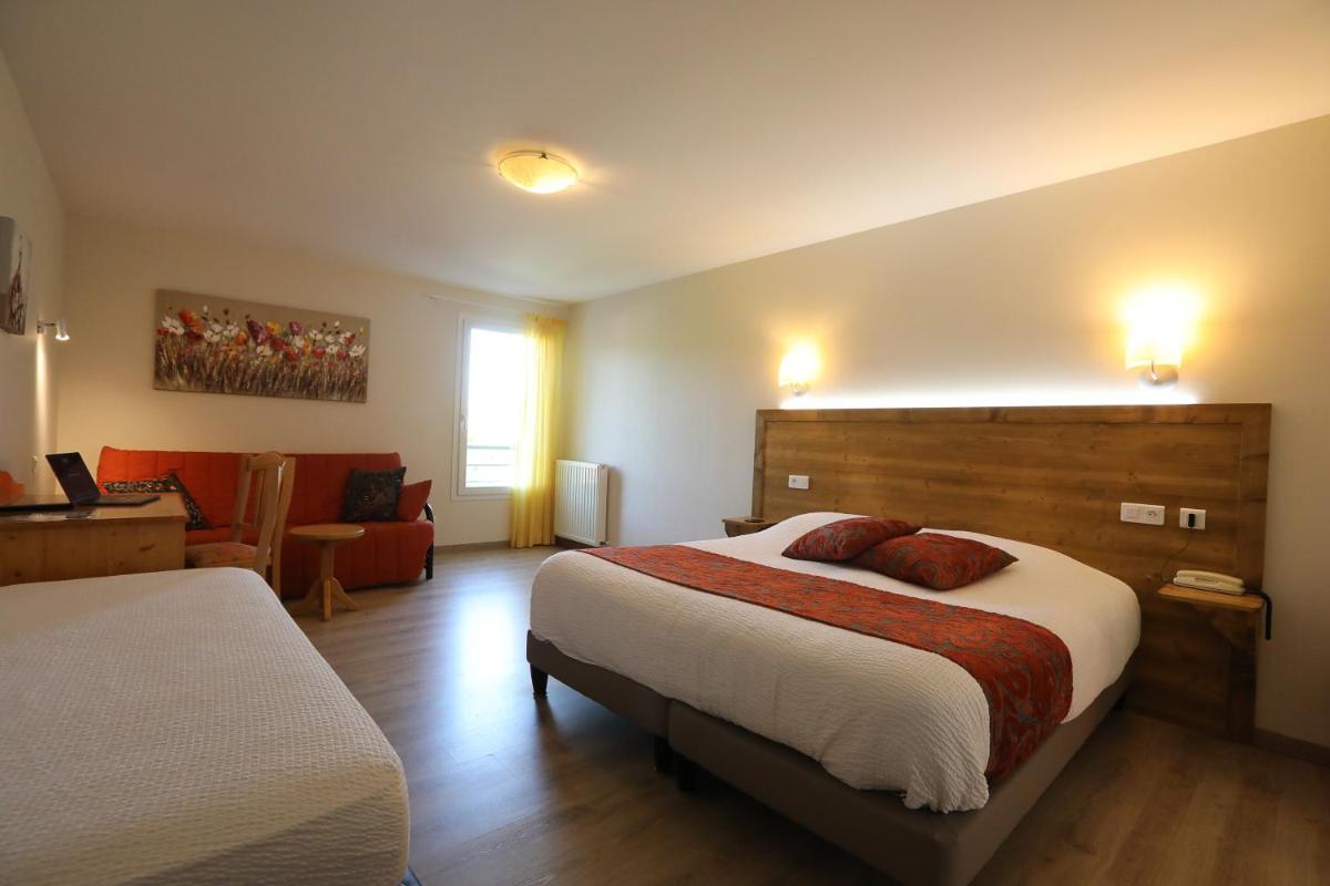 Un ou plusieurs lits dans un hébergement de l'établissement Logis Hotel Spa Restaurant Le Provence