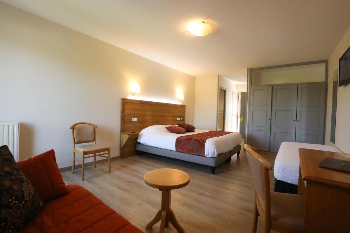 Un ou plusieurs lits dans un hébergement de l'établissement Logis Hotel Spa Restaurant Le Provence
