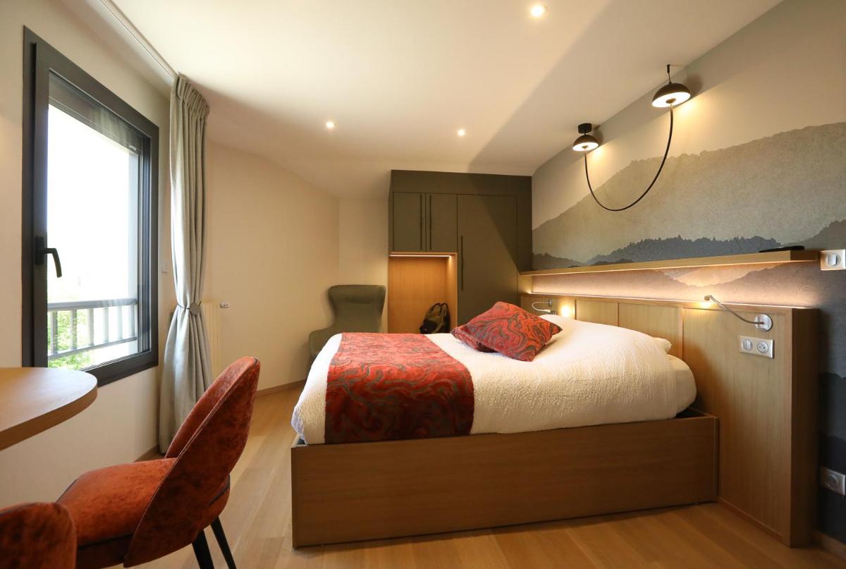 - une chambre avec un lit, une table et une chaise dans l'établissement Logis Hotel Spa Restaurant Le Provence, à Lanarce