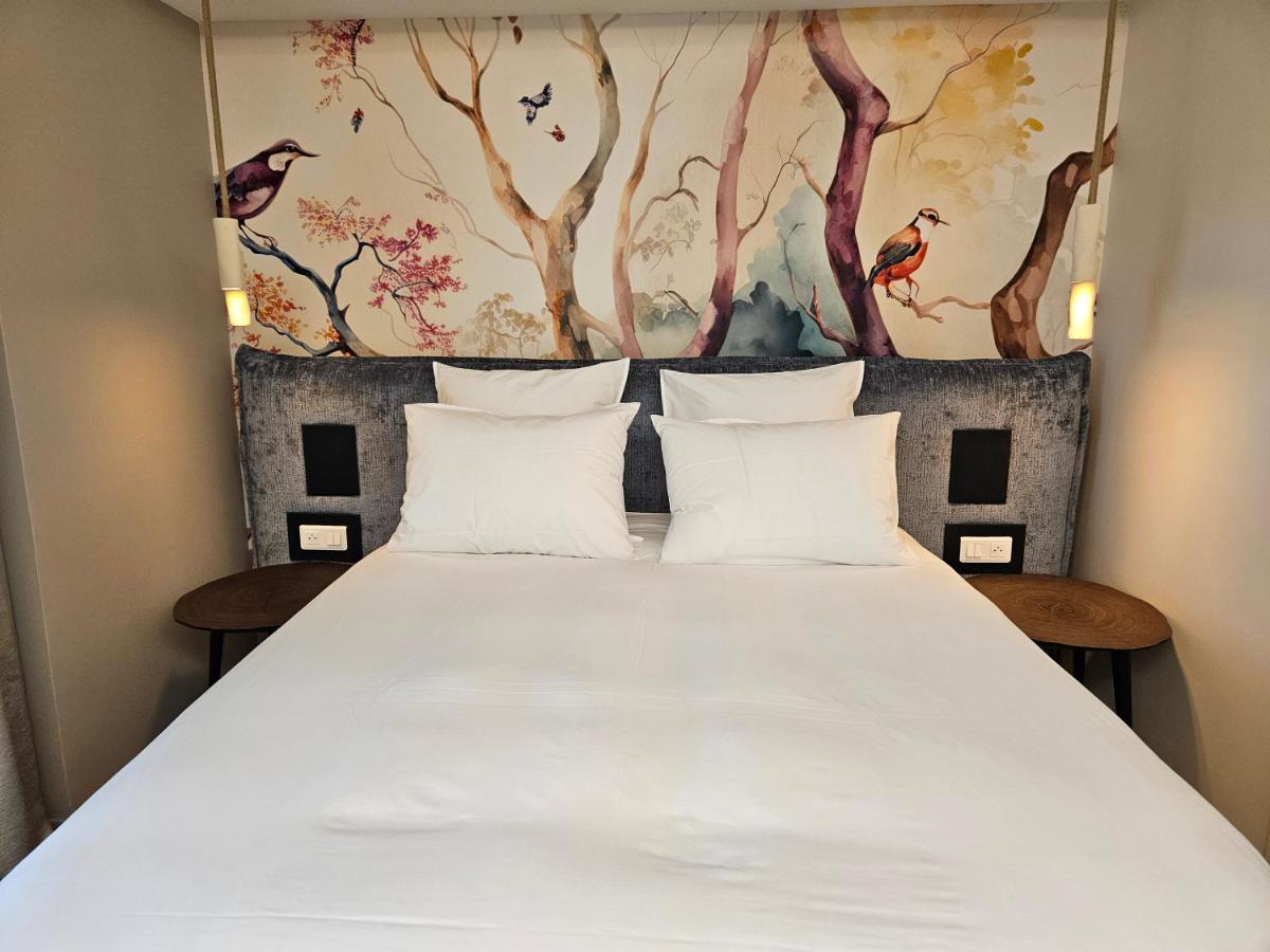 Un ou plusieurs lits dans un hébergement de l'établissement Le Belvédère Hotel et Bien être