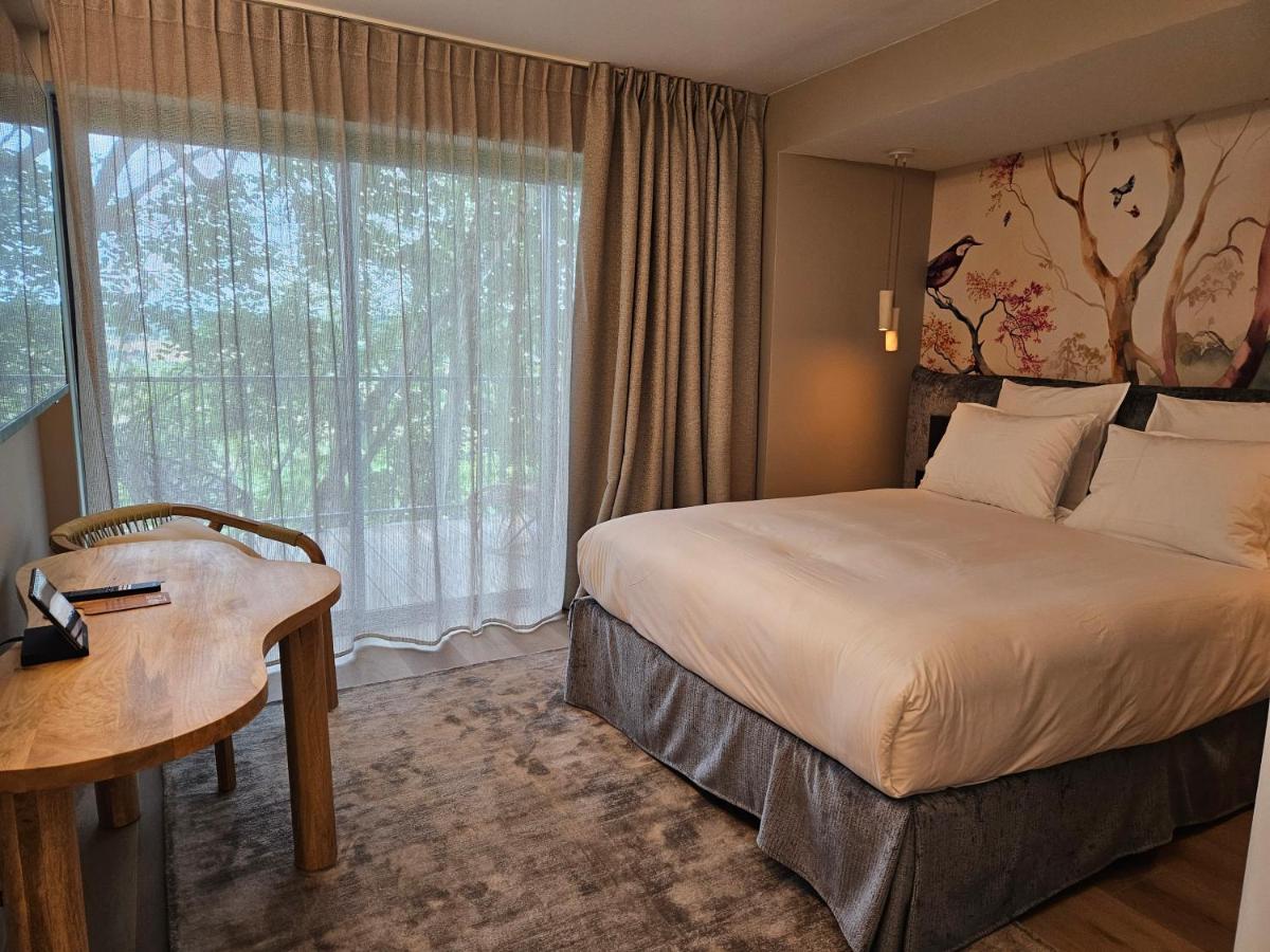 Un ou plusieurs lits dans un hébergement de l'établissement Le Belvédère Hotel et Bien être