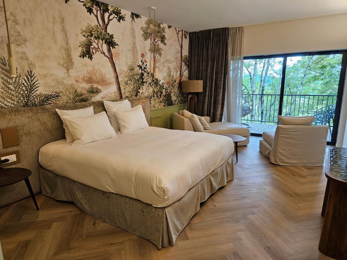 Un ou plusieurs lits dans un hébergement de l'établissement Le Belvédère Hotel et Bien être