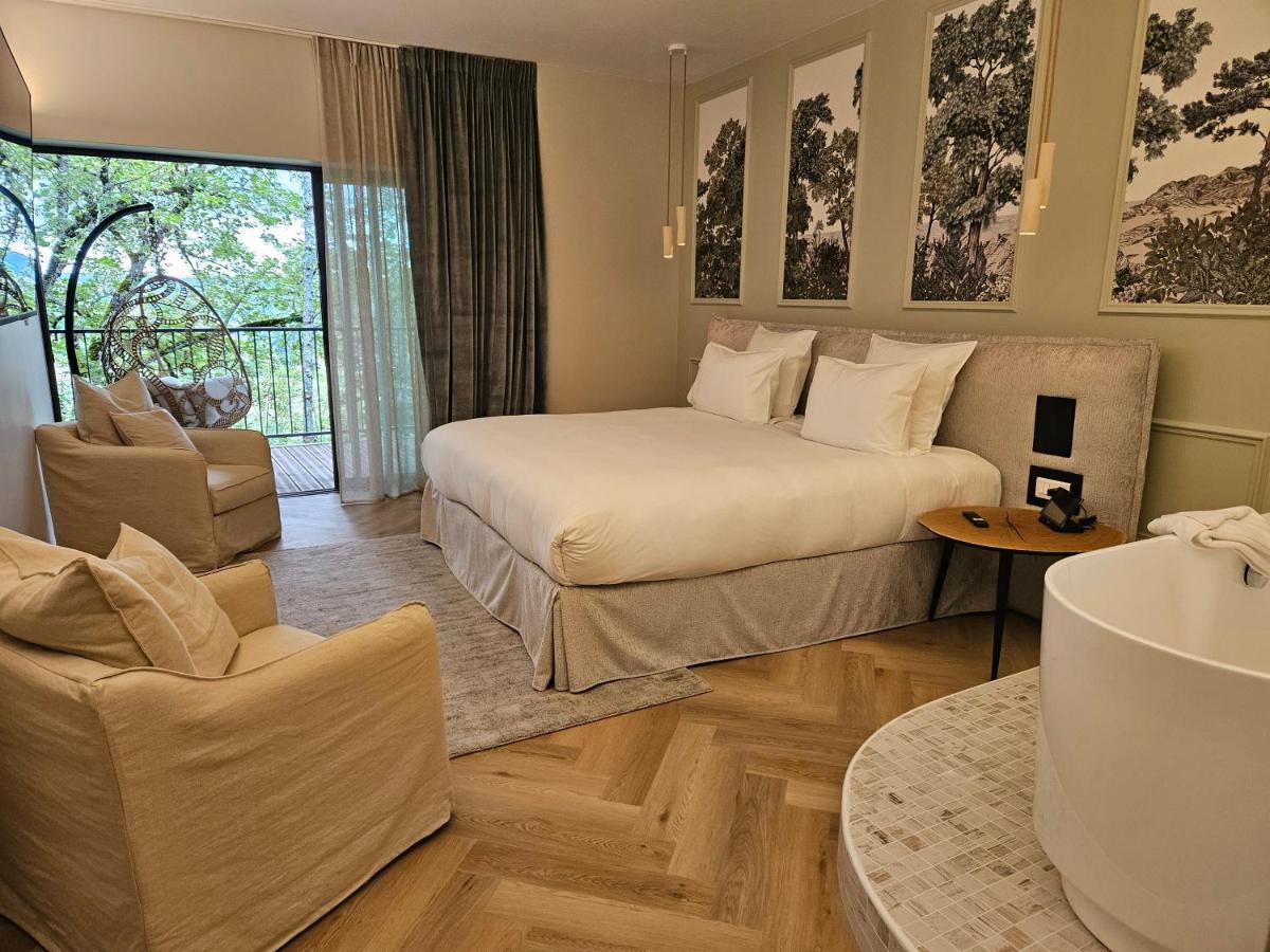 Un ou plusieurs lits dans un hébergement de l'établissement Le Belvédère Hotel et Bien être