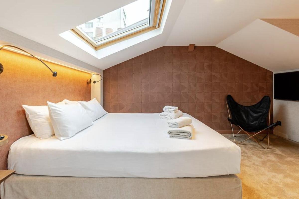 Un ou plusieurs lits dans un hébergement de l'établissement Atypik Hotel