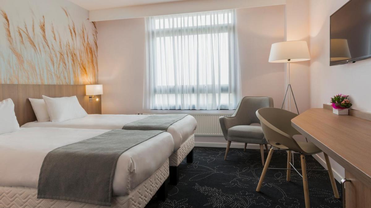 Un ou plusieurs lits dans un hébergement de l'établissement Holiday Inn Calais Coquelles by IHG