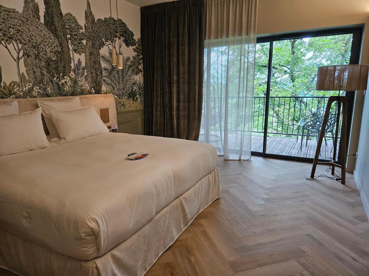 Un ou plusieurs lits dans un hébergement de l'établissement Le Belvédère Hotel et Bien être