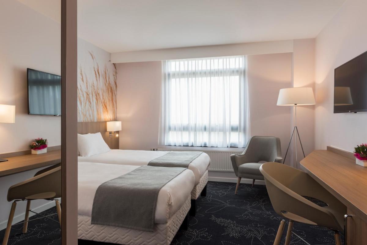 Un ou plusieurs lits dans un hébergement de l'établissement Holiday Inn Calais Coquelles by IHG