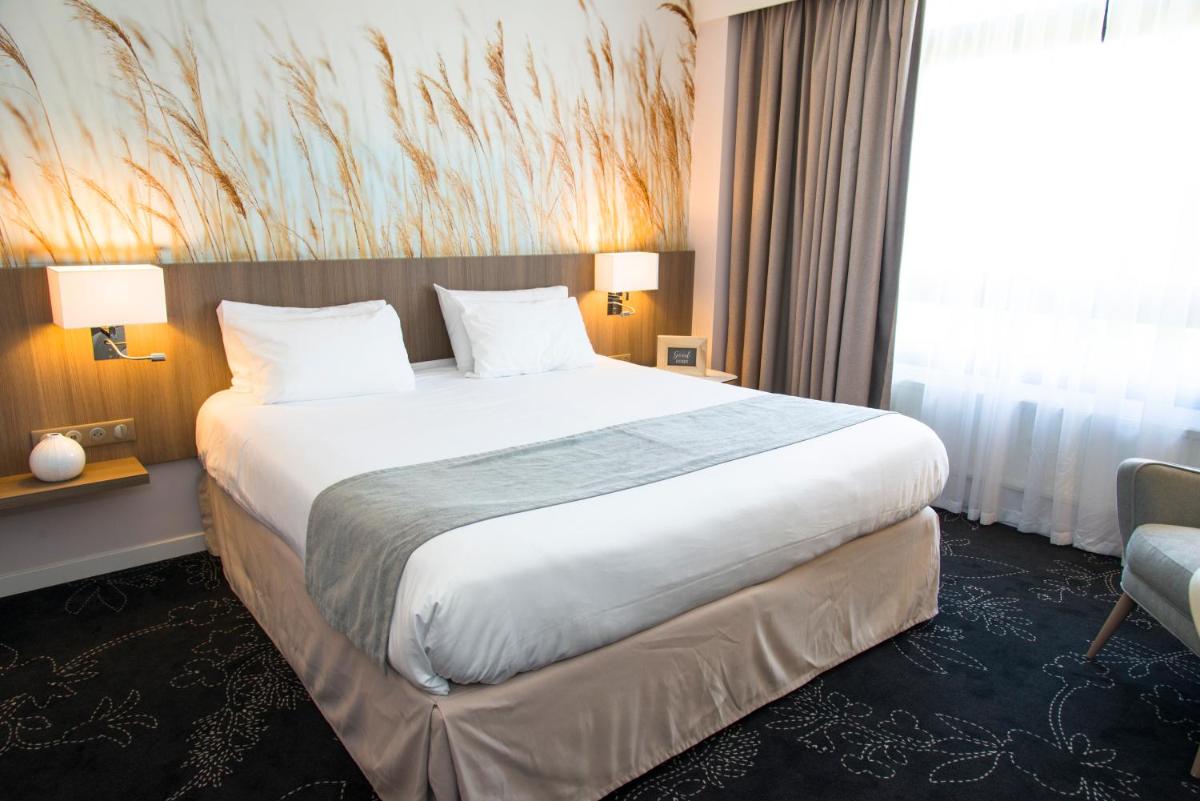 Un ou plusieurs lits dans un hébergement de l'établissement Holiday Inn Calais Coquelles by IHG