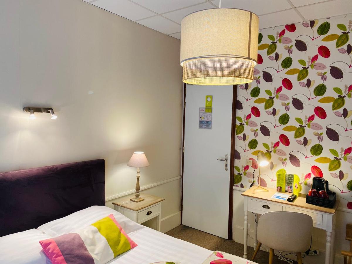 Un ou plusieurs lits dans un hébergement de l'établissement BRIT HOTEL & SPA Le Roc au Chien