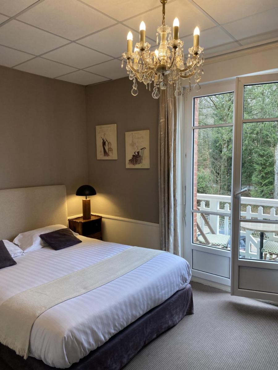 Un ou plusieurs lits dans un hébergement de l'établissement BRIT HOTEL & SPA Le Roc au Chien