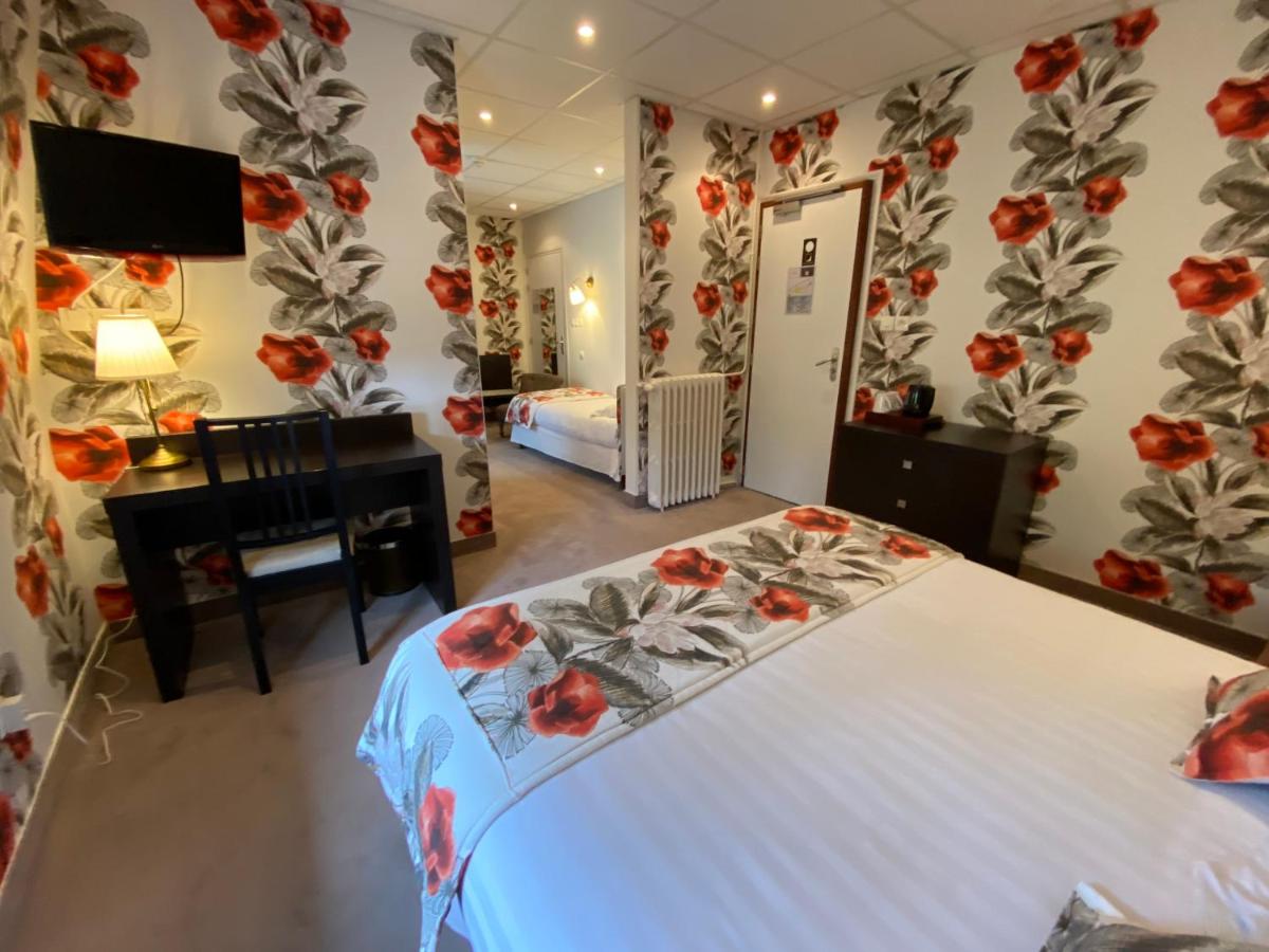 Un ou plusieurs lits dans un hébergement de l'établissement BRIT HOTEL & SPA Le Roc au Chien