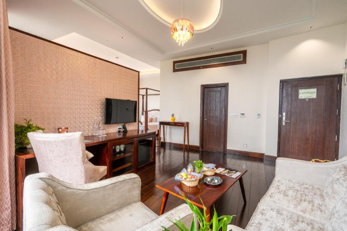a living room with two chairs and a table at The Orchid Shimla in Shimla