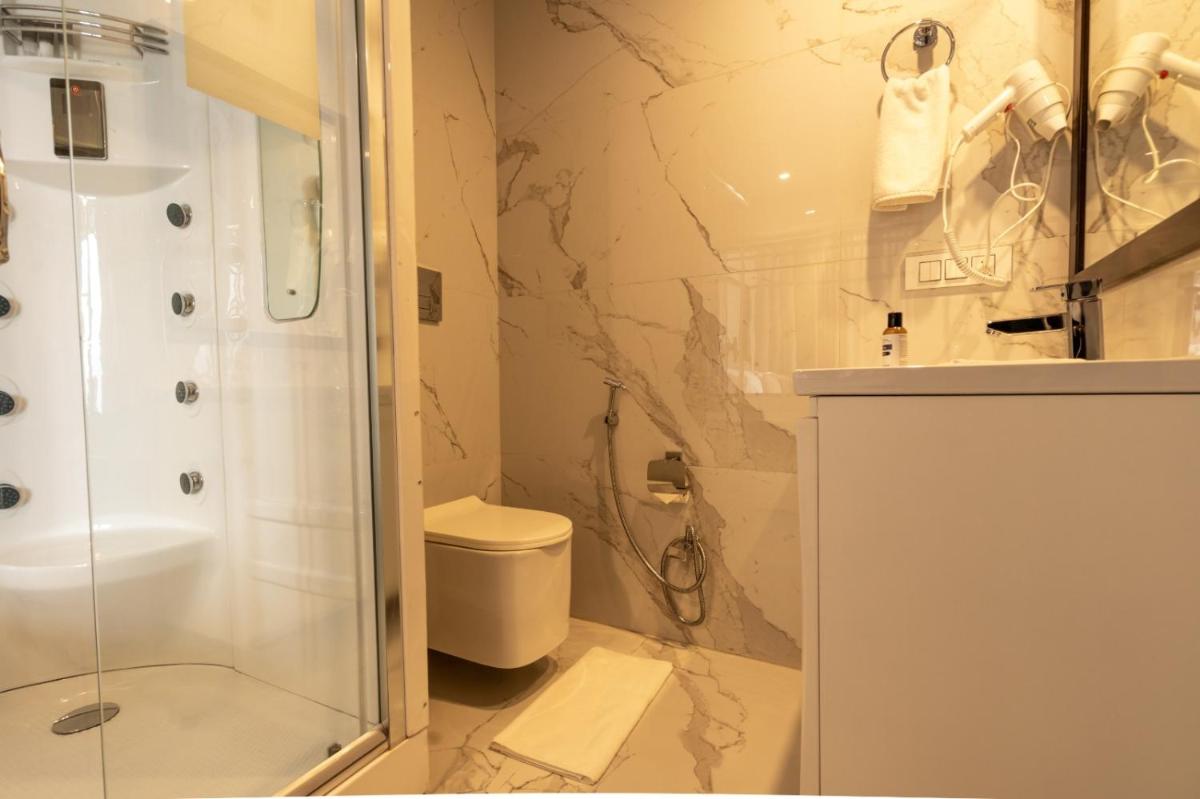 a bathroom with a shower and a toilet at The Orchid Shimla in Shimla