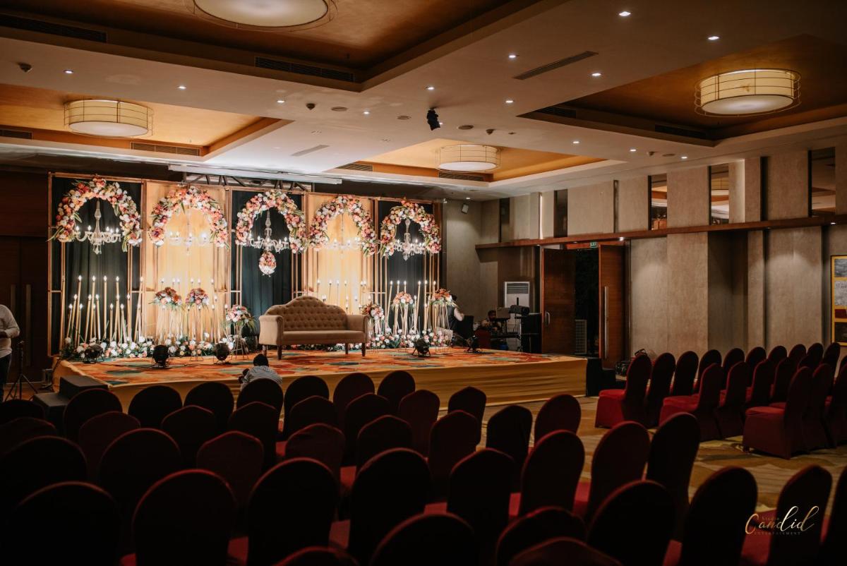 an empty auditorium with a stage and chairs at Renaissance Ahmedabad Hotel in Ahmedabad