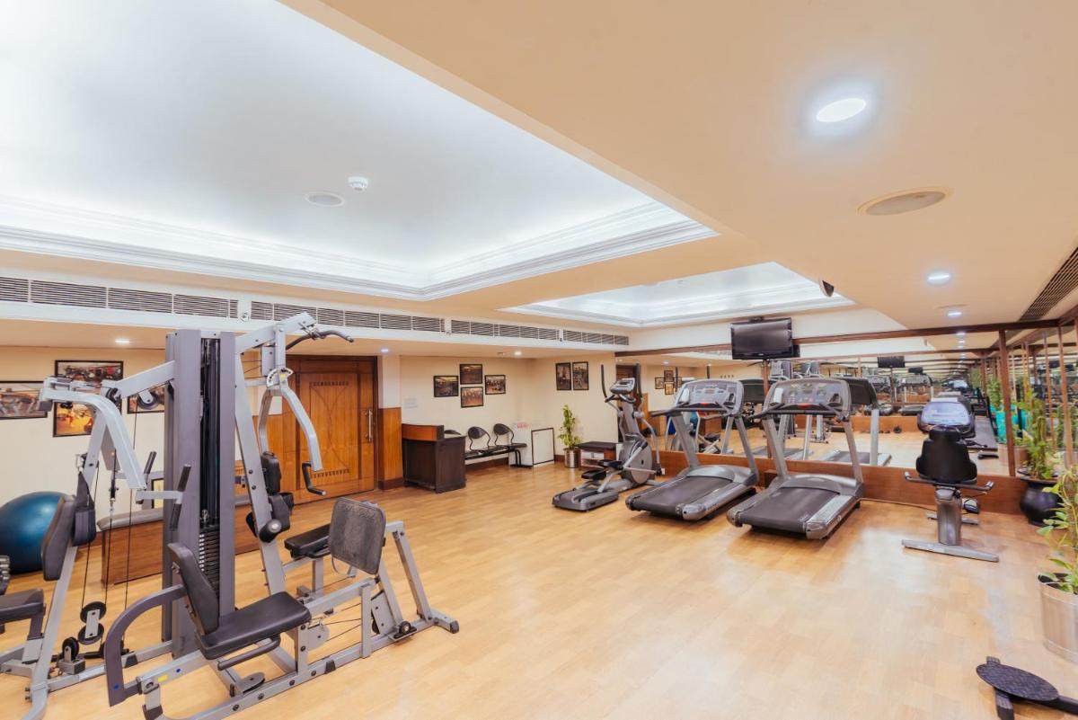 a gym with treadmills and elliptical machines at The Piccadily in Lucknow