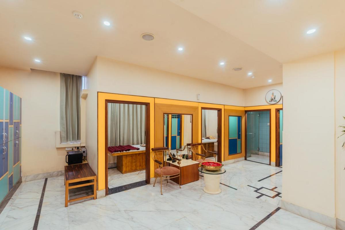 a room with a desk and a clock on the wall at The Piccadily in Lucknow