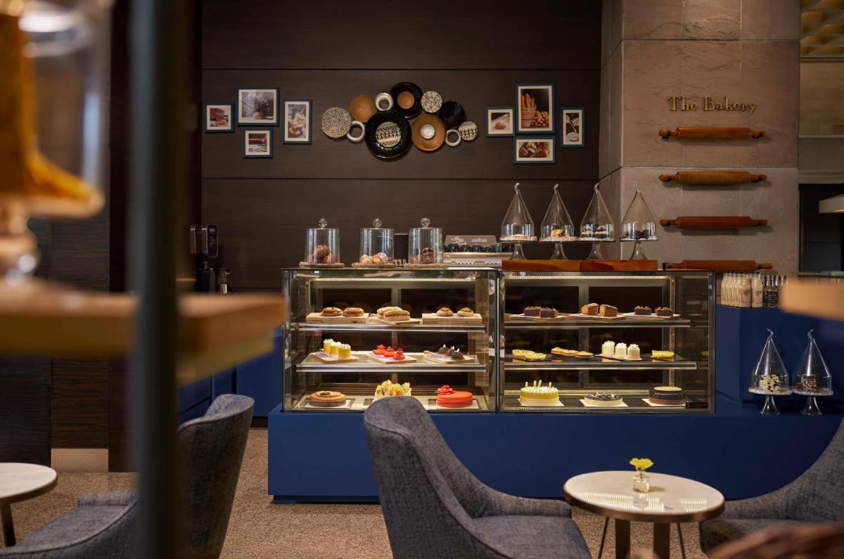 a bakery with a display case full of pastries at Hyatt Regency Kolkata in Kolkata a bakery with a display case full of pastries at Hyatt Regency Kolkata in Kolkata