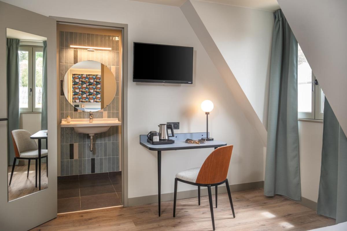 Télévision ou salle de divertissement dans l'établissement La Maison Rabelais
