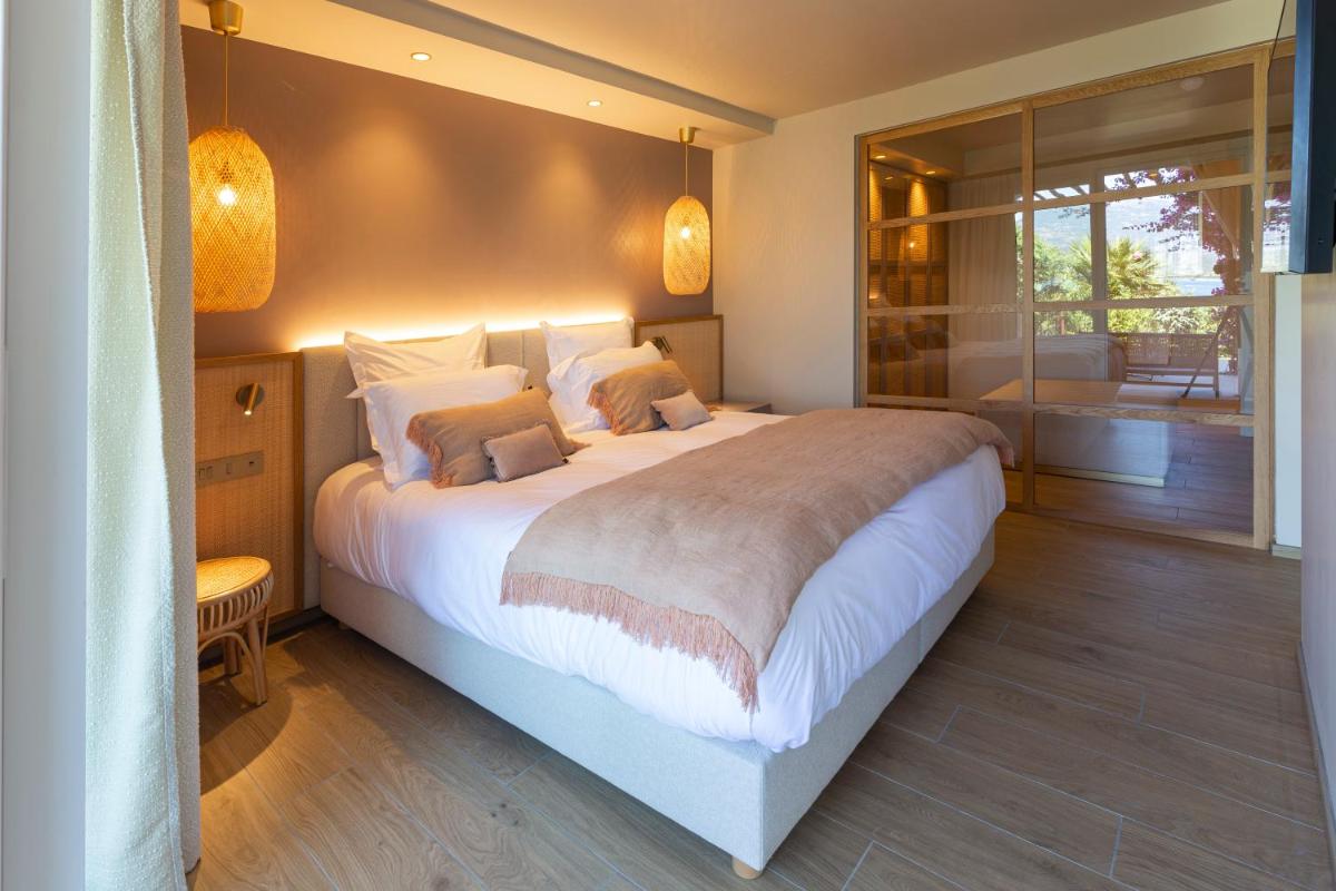 Un ou plusieurs lits dans un hébergement de l'établissement Hotel Riva Beach
