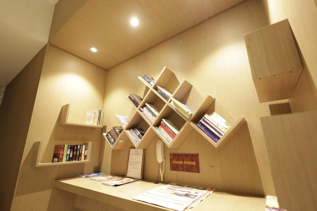 a room with shelves on the wall with books at Ramada by Wyndham Lucknow Hotel and Convention Center in Lucknow