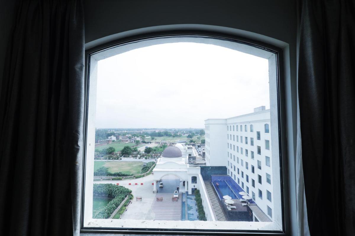 a window view of a city from a building at Ramada by Wyndham Lucknow Hotel and Convention Center in Lucknow