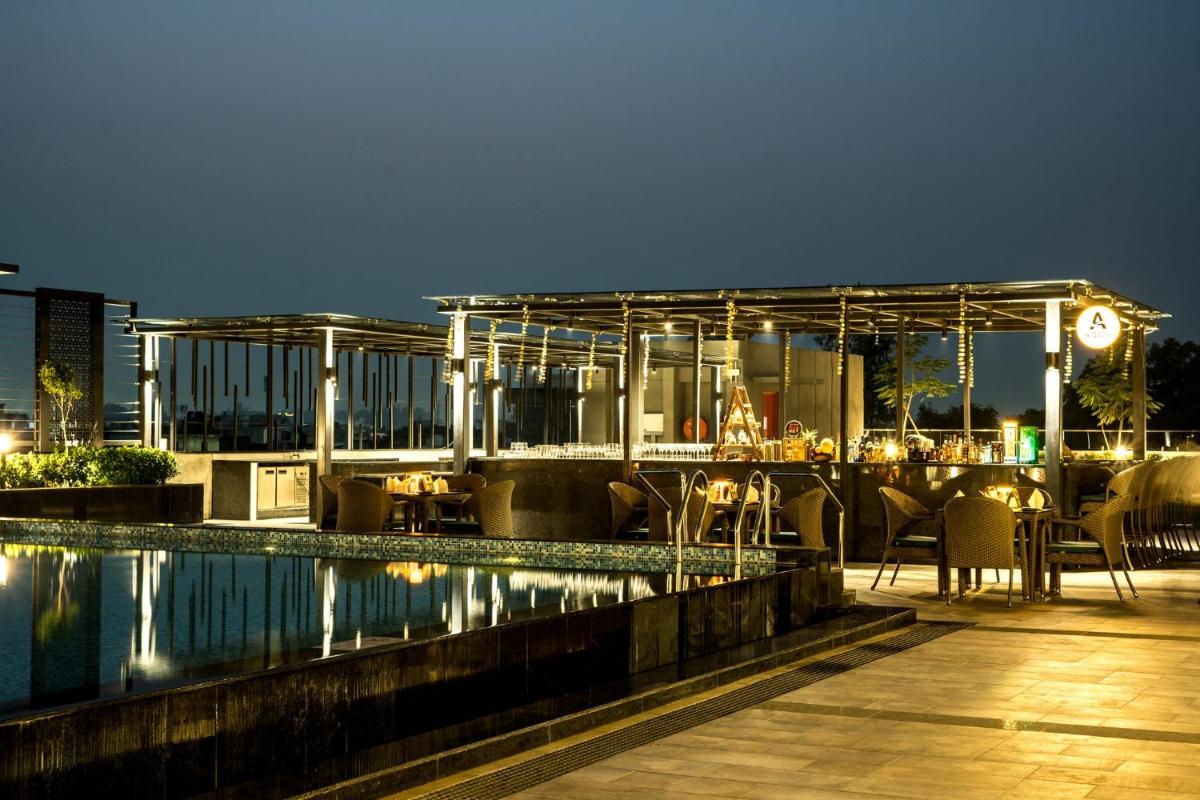 a resort with a swimming pool at night at Holiday Inn Lucknow Airport by IHG in Lucknow