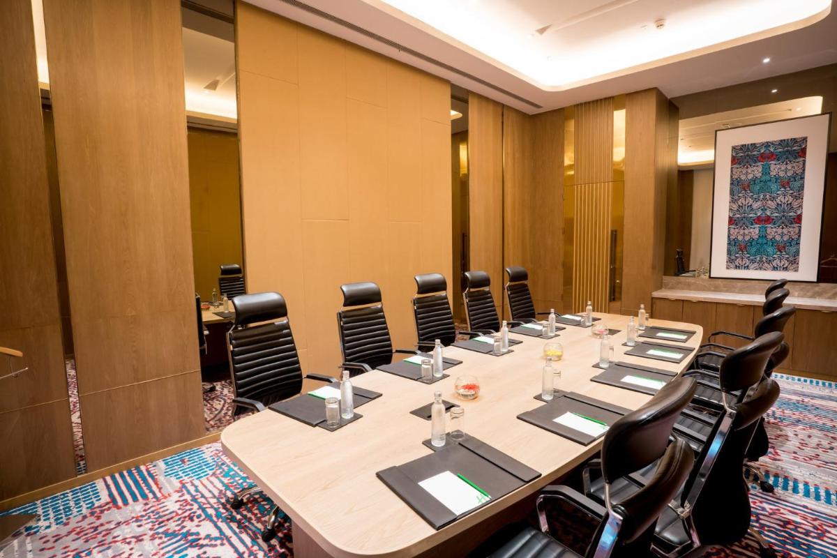a conference room with a long table and chairs at Holiday Inn Lucknow Airport by IHG in Lucknow