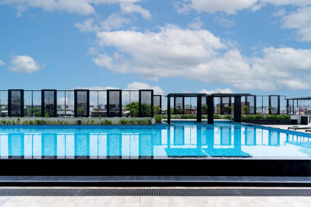 a large swimming pool on top of a building at Holiday Inn Lucknow Airport by IHG in Lucknow