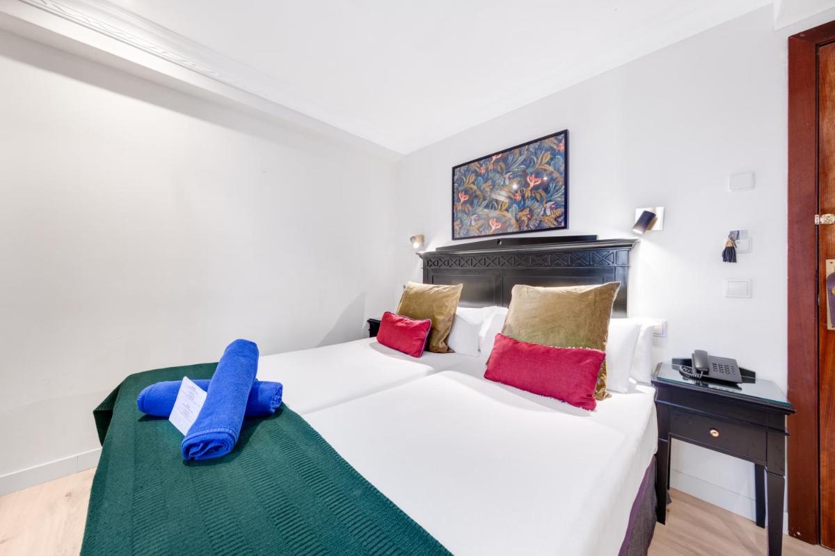 Cama o camas de una habitación en Hotel Ciutat Jardi