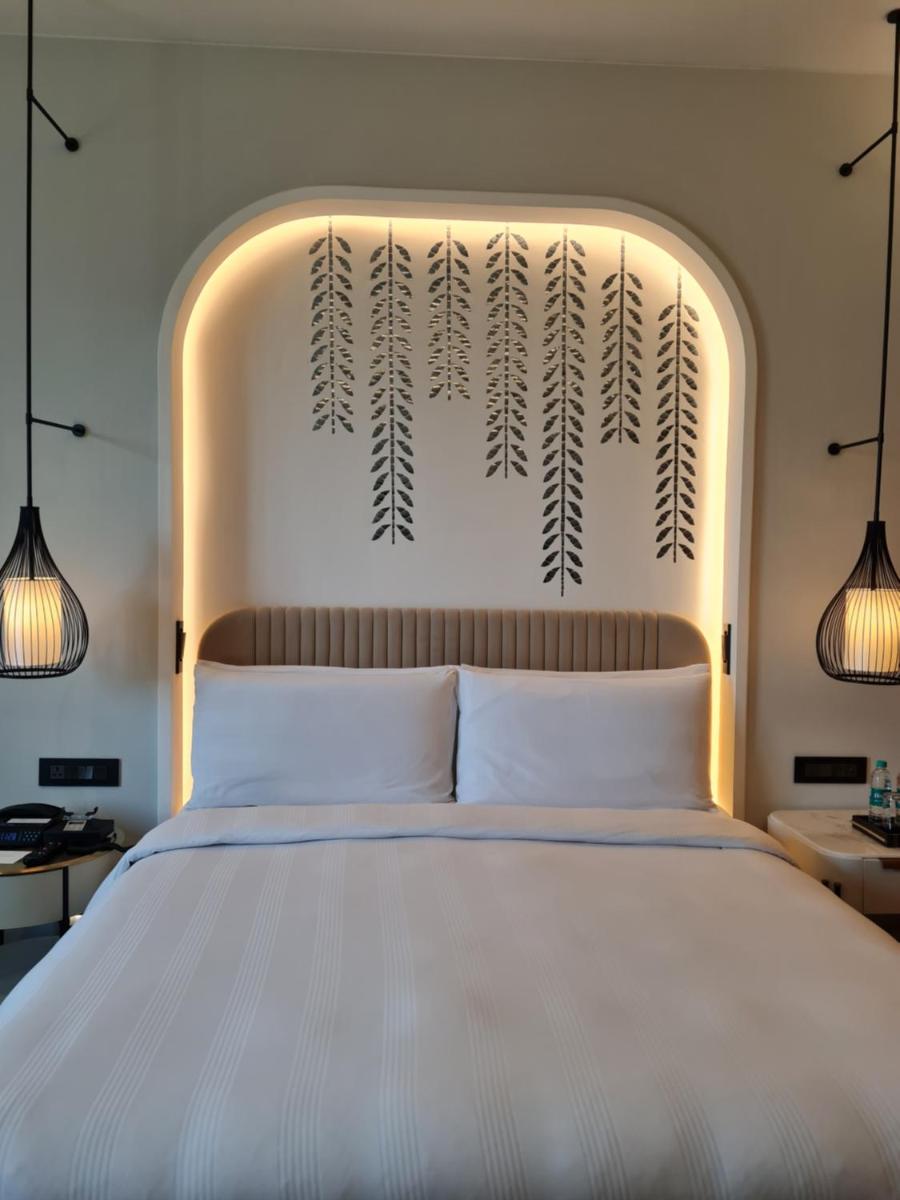 a bedroom with a large white bed with a headboard at InterContinental Jaipur Tonk Road by IHG in Jaipur