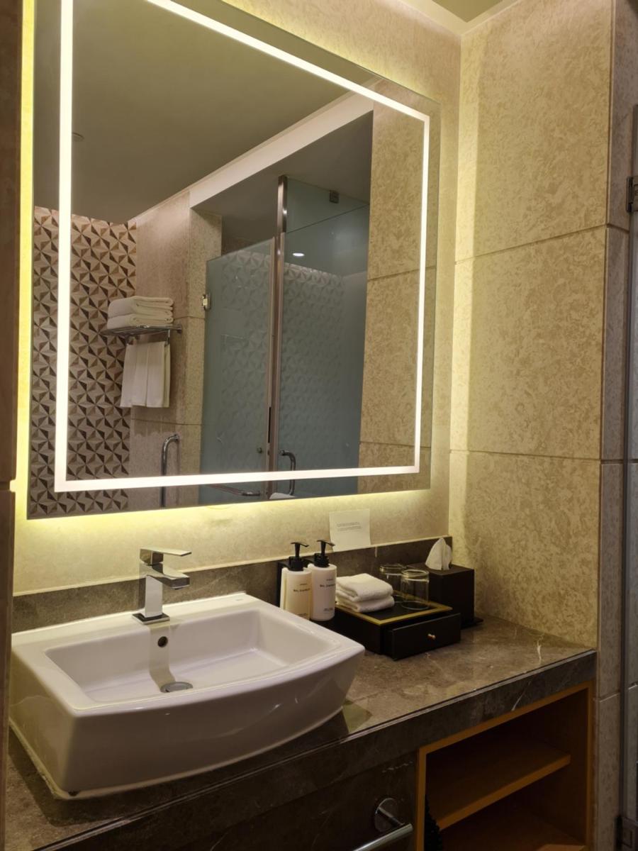 a bathroom with a sink and a large mirror at InterContinental Jaipur Tonk Road by IHG in Jaipur