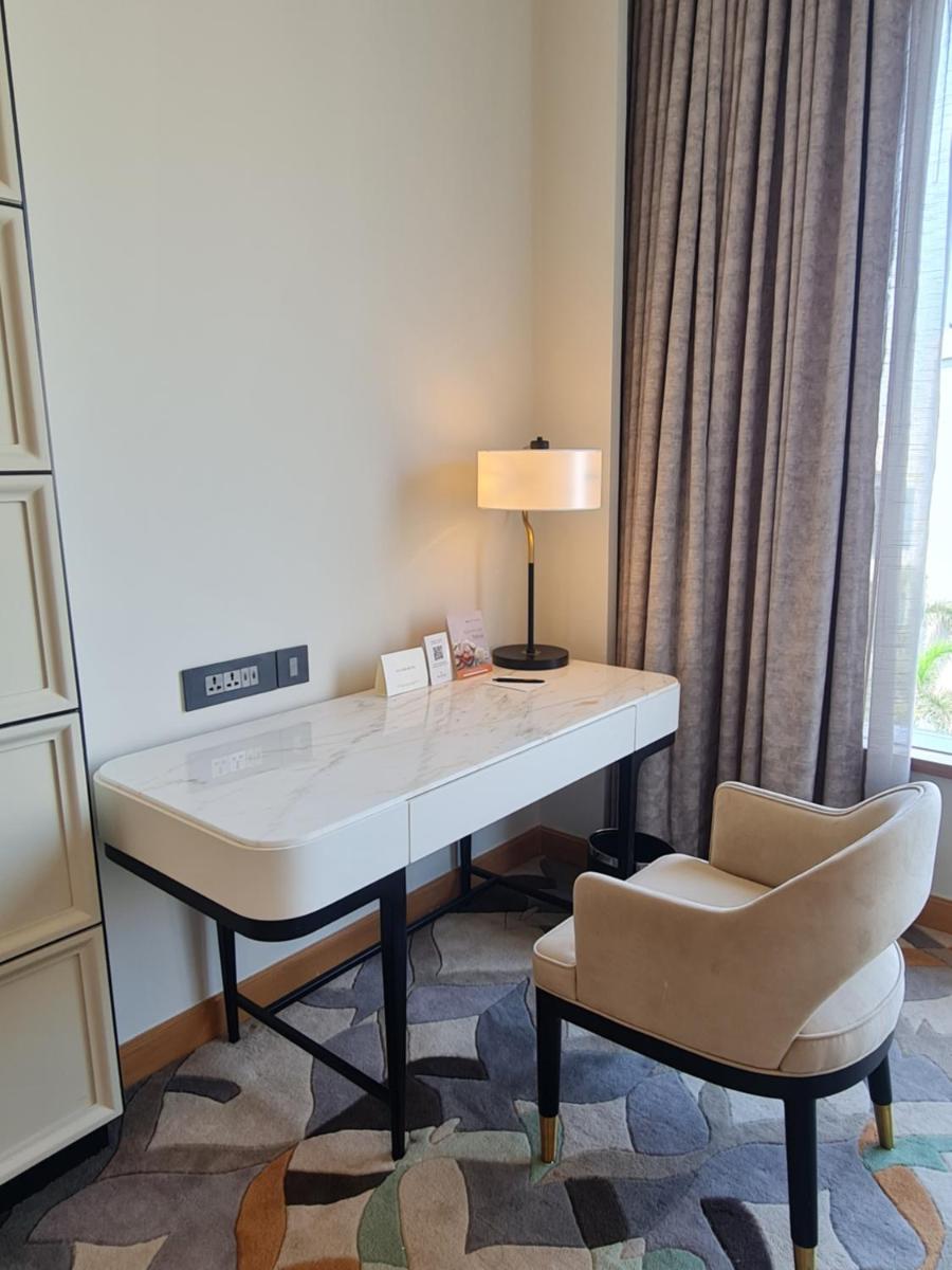 a desk with a lamp and a chair in a room at InterContinental Jaipur Tonk Road by IHG in Jaipur