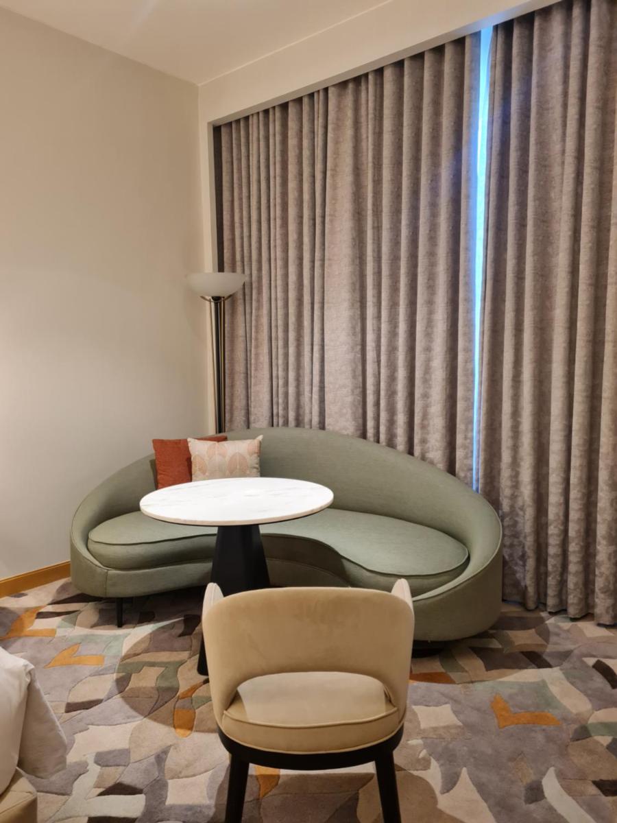a living room with a couch and a table at InterContinental Jaipur Tonk Road by IHG in Jaipur