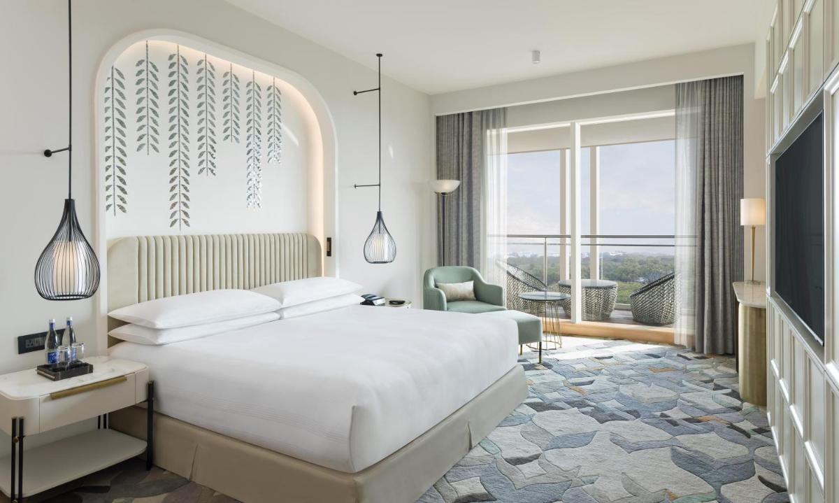 a bedroom with a white bed and a large window at InterContinental Jaipur Tonk Road by IHG in Jaipur