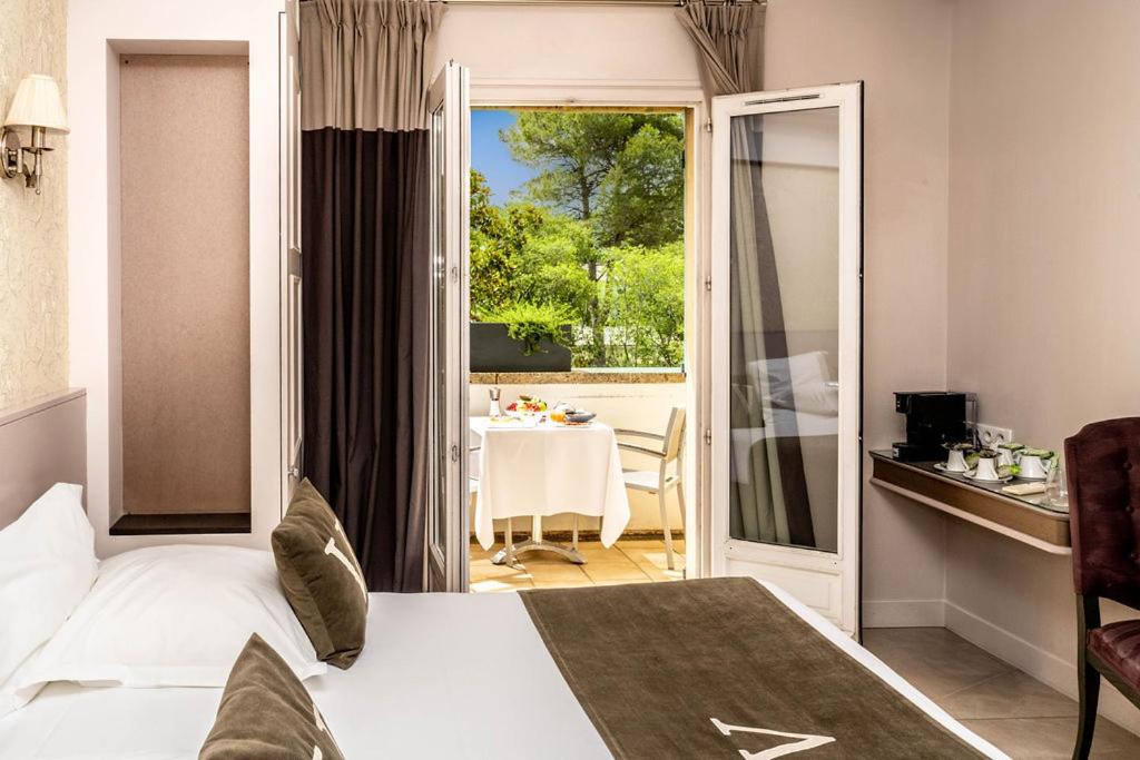 Un ou plusieurs lits dans un hébergement de l'établissement Le Vallon de Valrugues Hotel Spa & Villas