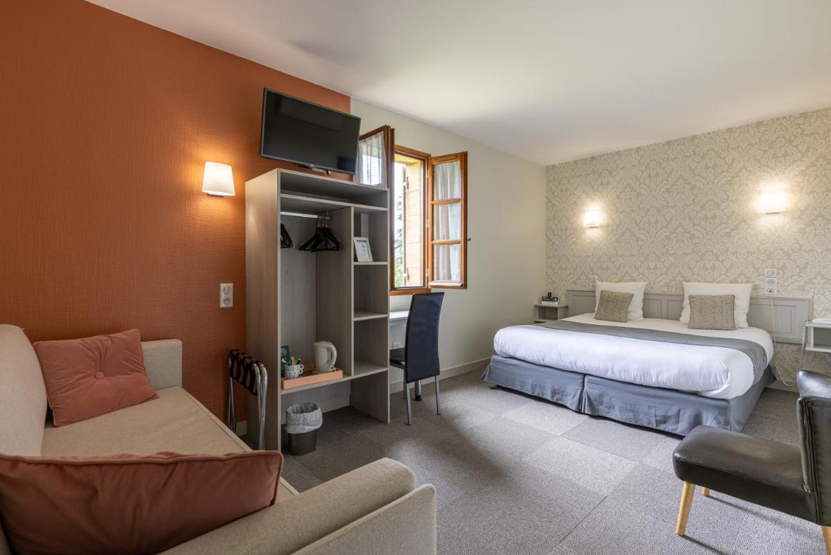 Un ou plusieurs lits dans un hébergement de l'établissement Logis Hotel Archambeau