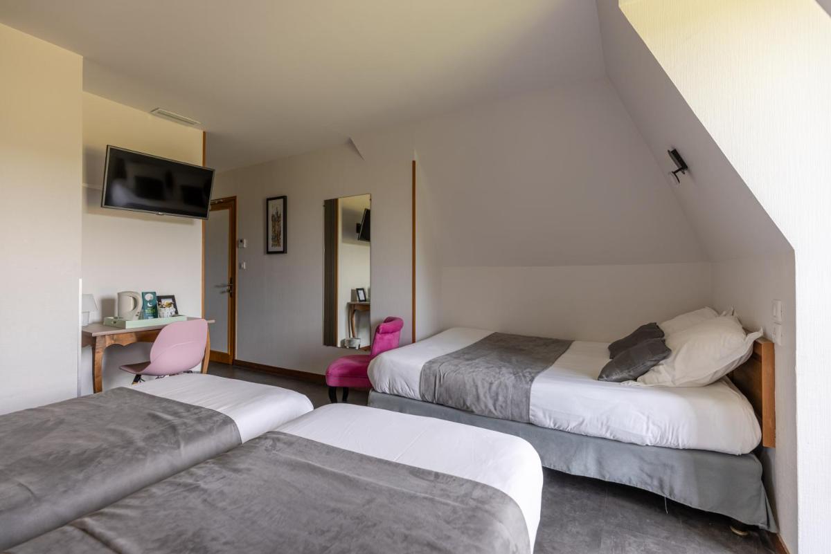 Un ou plusieurs lits dans un hébergement de l'établissement Logis Hotel Archambeau