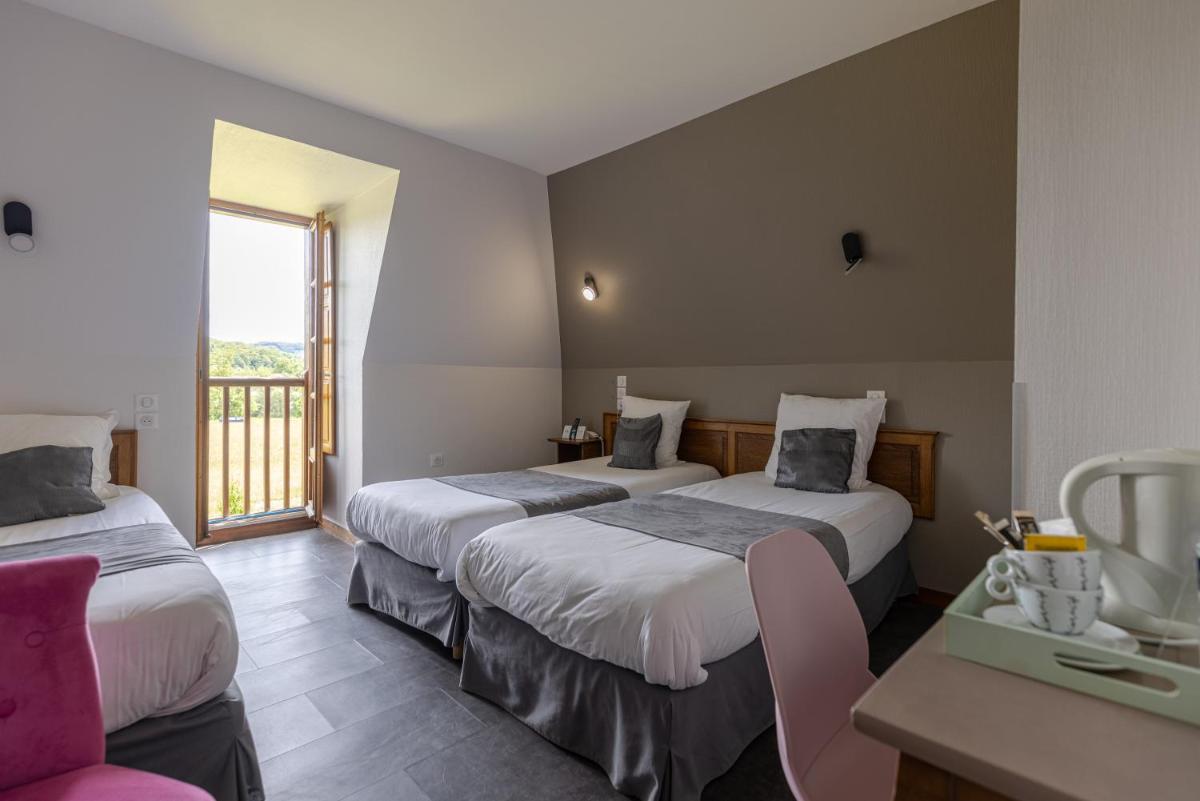 Un ou plusieurs lits dans un hébergement de l'établissement Logis Hotel Archambeau