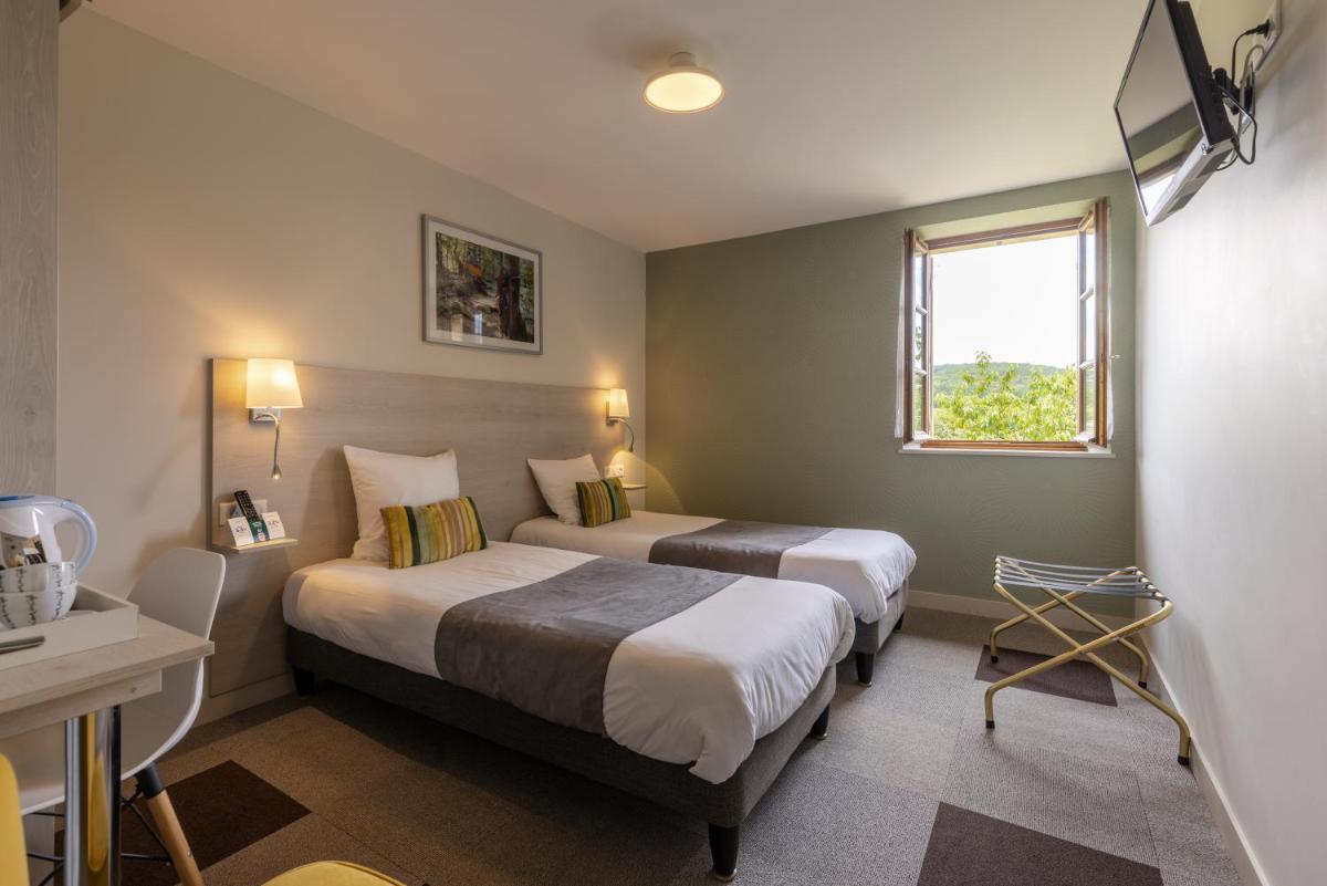 Un ou plusieurs lits dans un hébergement de l'établissement Logis Hotel Archambeau