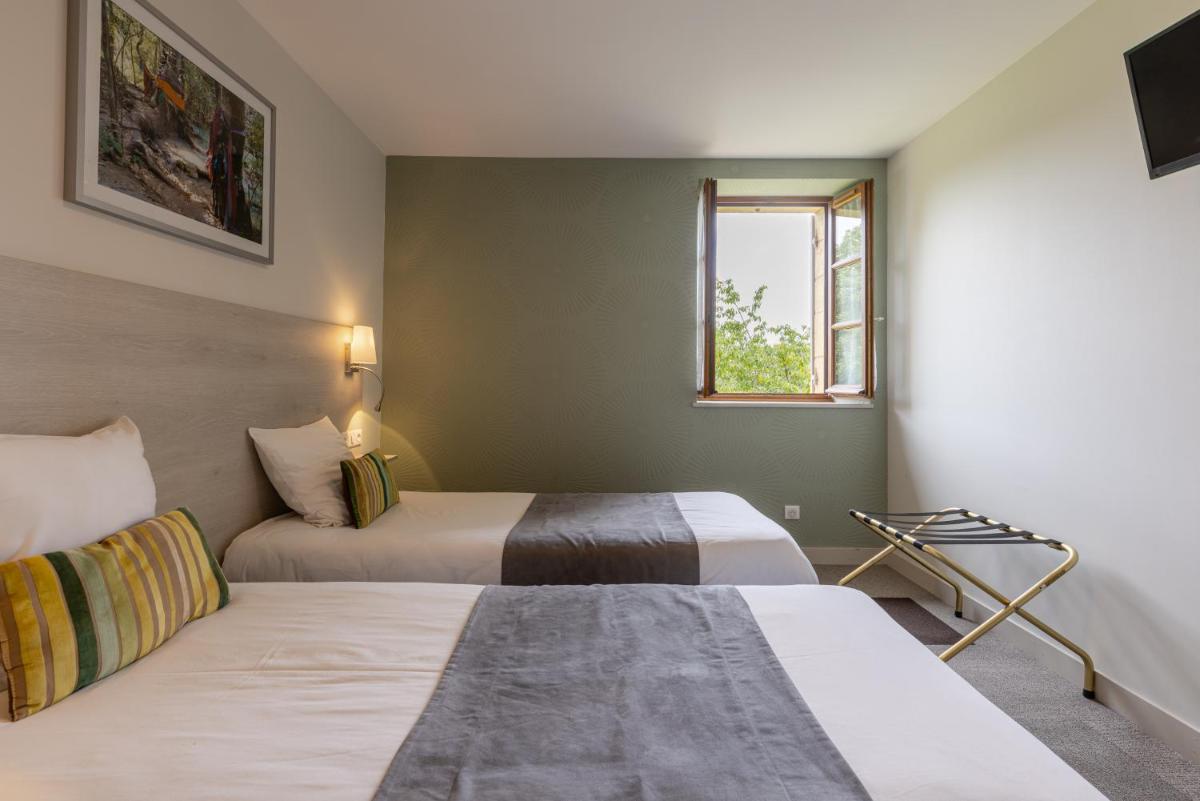 Un ou plusieurs lits dans un hébergement de l'établissement Logis Hotel Archambeau