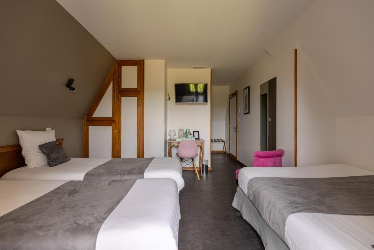 Un ou plusieurs lits dans un hébergement de l'établissement Logis Hotel Archambeau