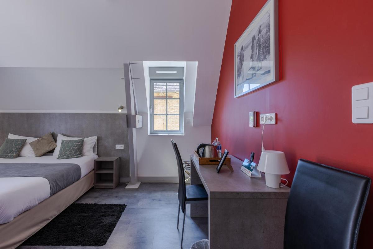 Un ou plusieurs lits dans un hébergement de l'établissement Logis Hotel Archambeau