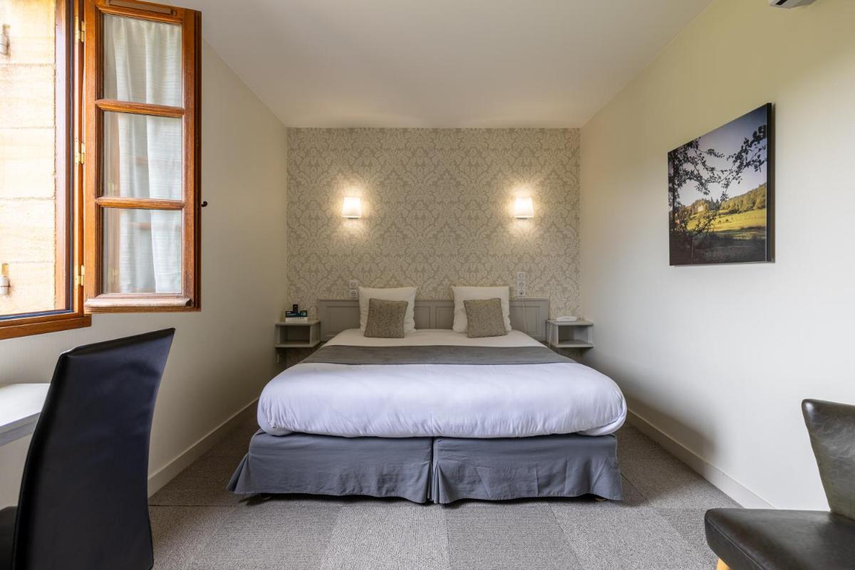 Un ou plusieurs lits dans un hébergement de l'établissement Logis Hotel Archambeau